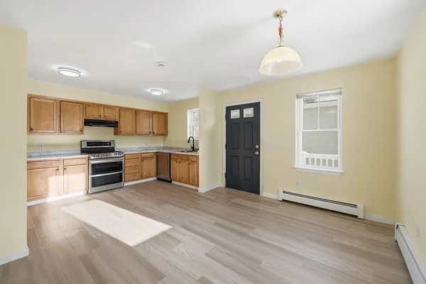 a kitchen with granite countertop cabinets stainless steel appliances and a sink