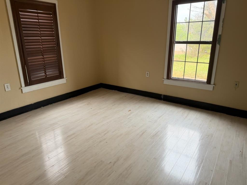 4050 Old Anson Road Abilene, TX 79601 - Photo 6 of 40 a view of an empty room with wooden floor and a window