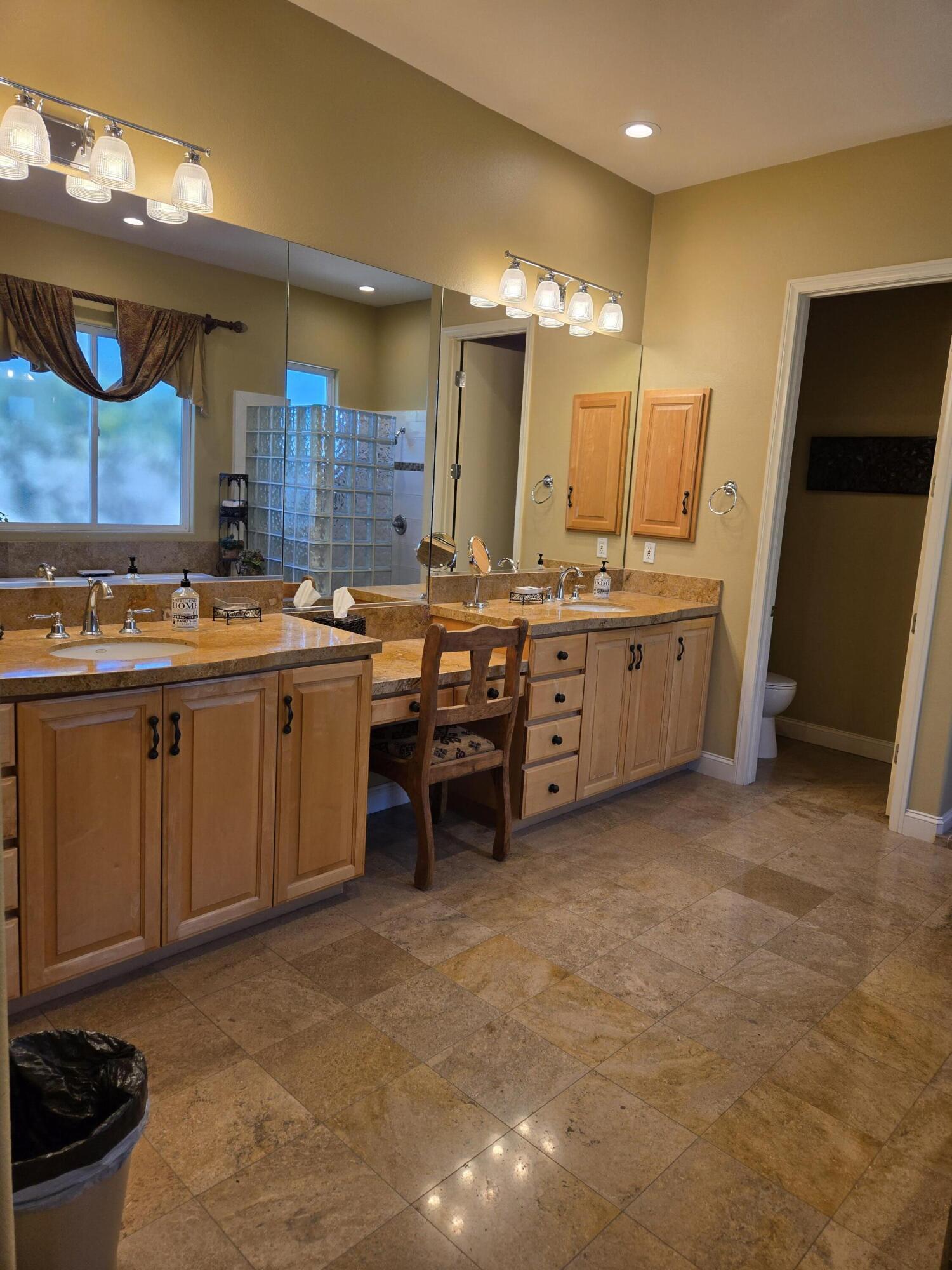 15 Vía Verde Rancho Mirage, CA 92270 - Photo 14 of 23 a kitchen with stainless steel appliances granite countertop a sink a stove and a refrigerator