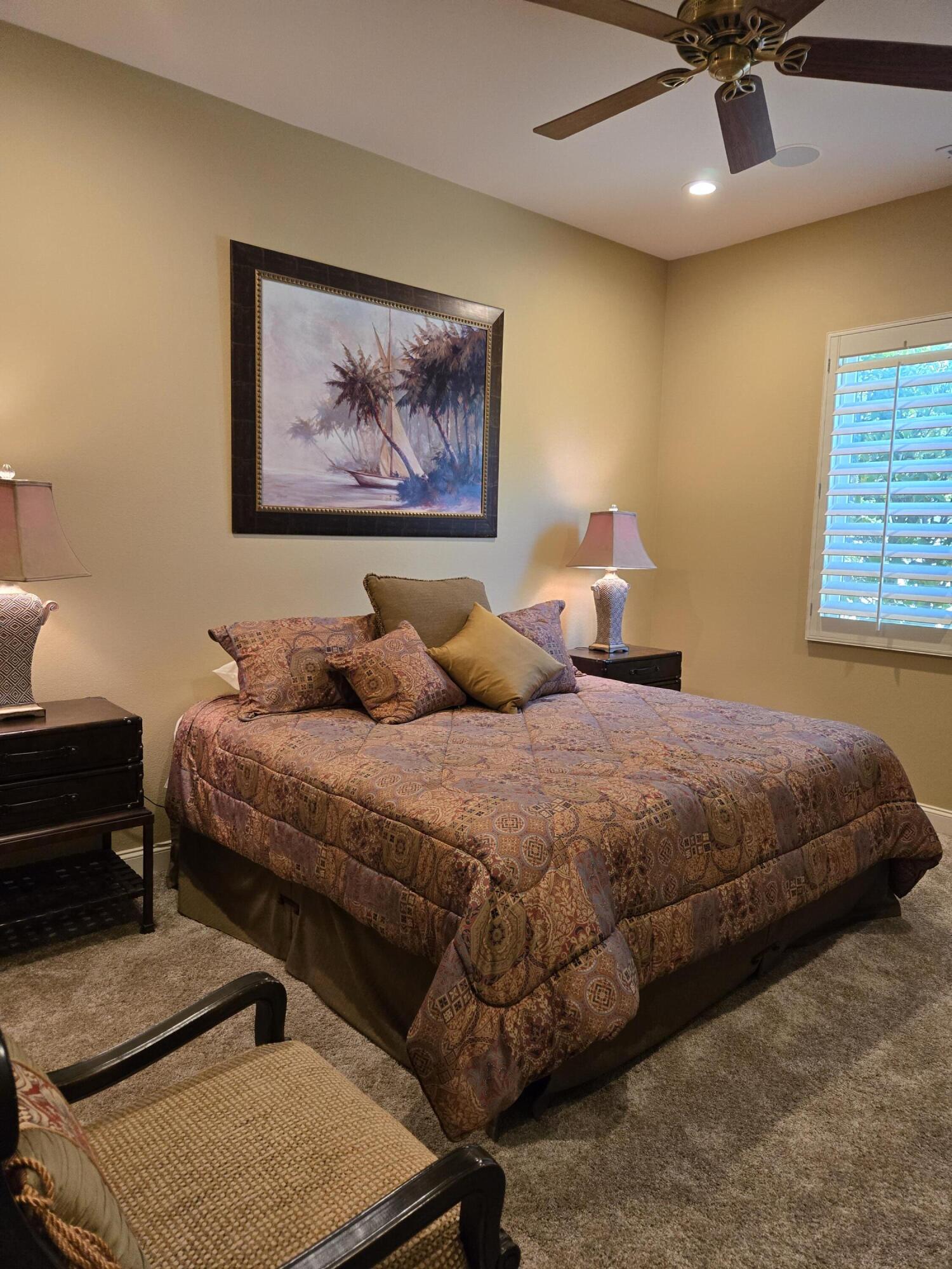 15 Vía Verde Rancho Mirage, CA 92270 - Photo 16 of 23 a bedroom with a bed and a chandelier