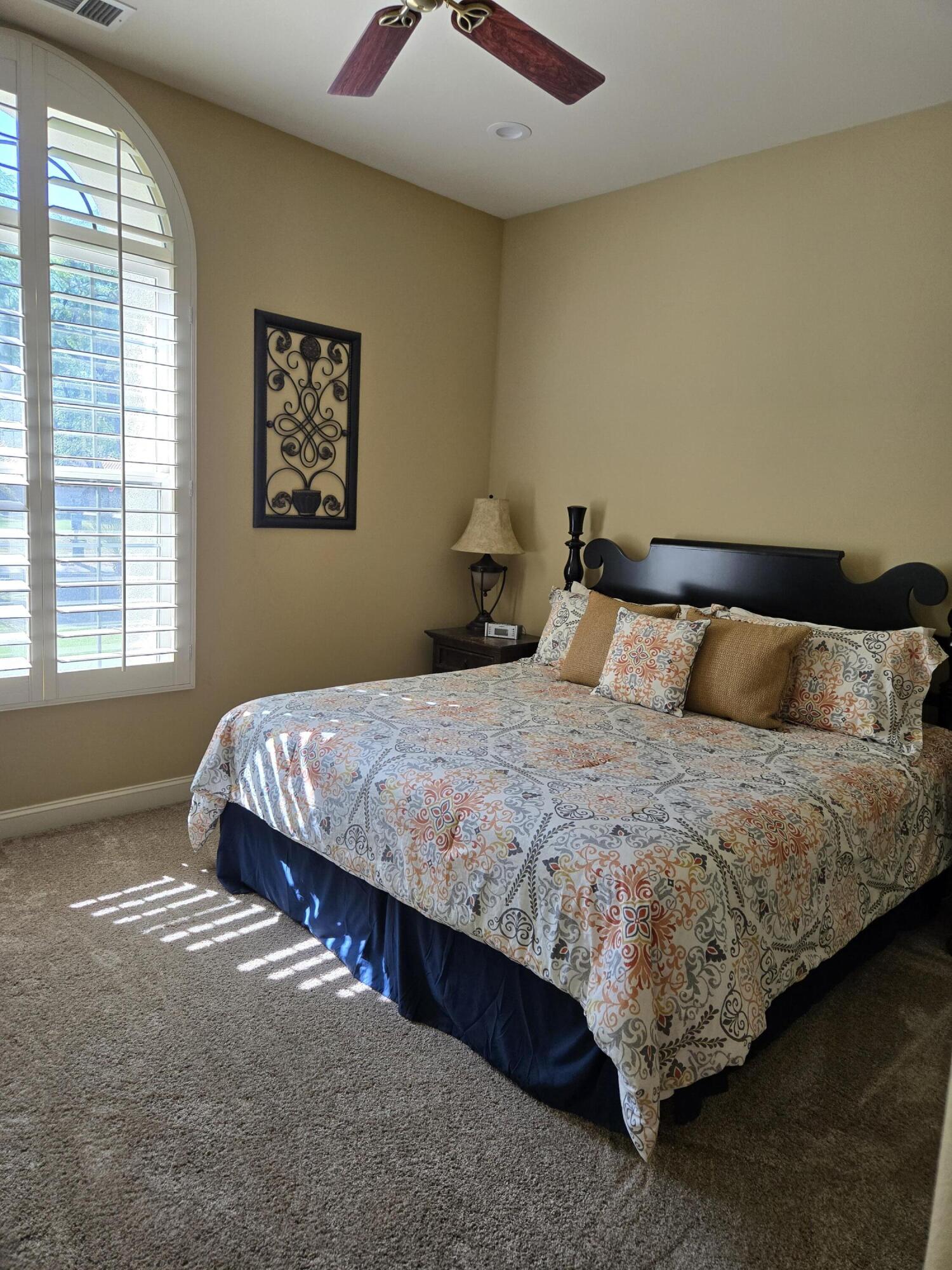 15 Vía Verde Rancho Mirage, CA 92270 - Photo 16 of 23 a bedroom with a bed and window