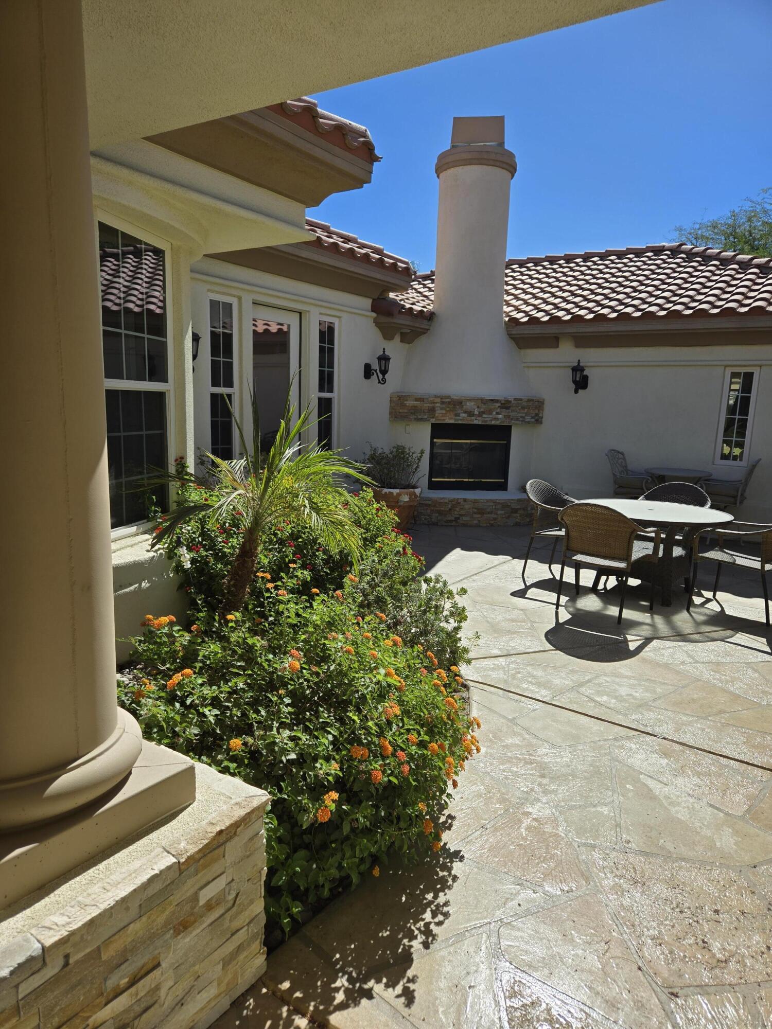 15 Vía Verde Rancho Mirage, CA 92270 - Photo 21 of 23 a view of a patio with table and chairs potted plants
