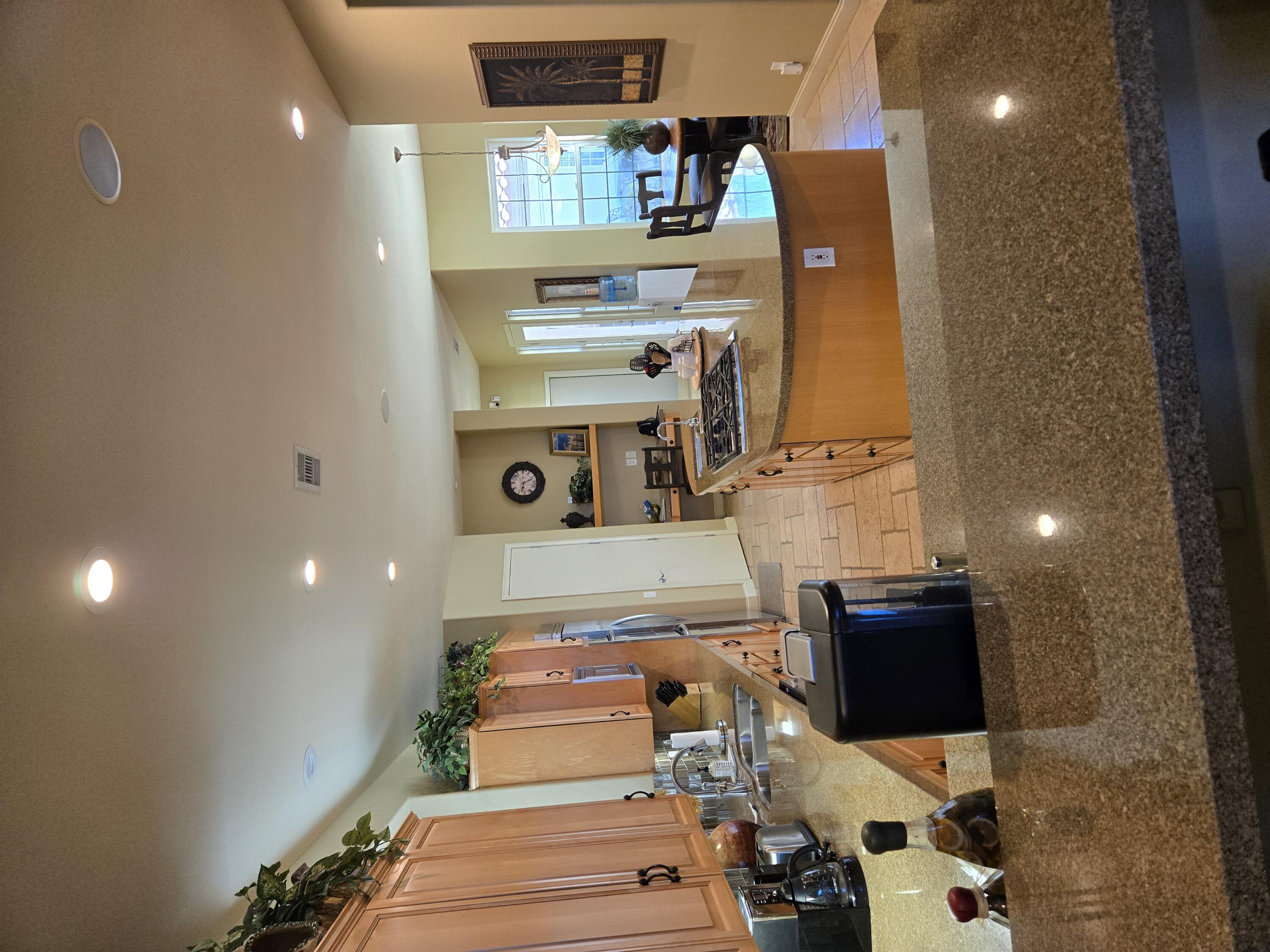 15 Vía Verde Rancho Mirage, CA 92270 - Photo 23 of 23 a room with stainless steel appliances kitchen island a stove and a wooden floor