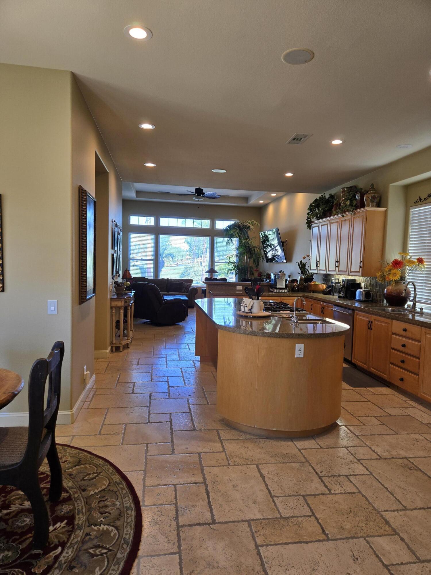 15 Vía Verde Rancho Mirage, CA 92270 - Photo 4 of 23 a living room with furniture a wooden floor and kitchen view