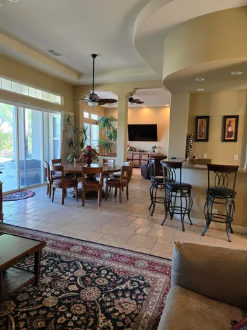 a living room with furniture a large window and a rug