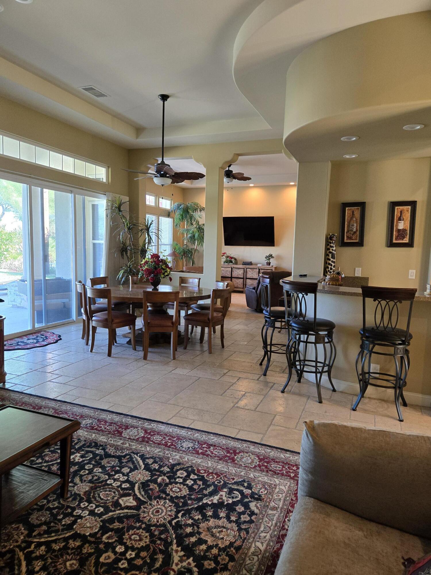 15 Vía Verde Rancho Mirage, CA 92270 - Photo 9 of 23 a living room with furniture a large window and a rug