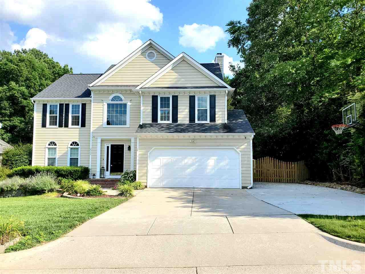 2332 Finley Ridge Lane Raleigh, NC 27615 - Photo 1 of 30 a front view of a house with a garden and garage