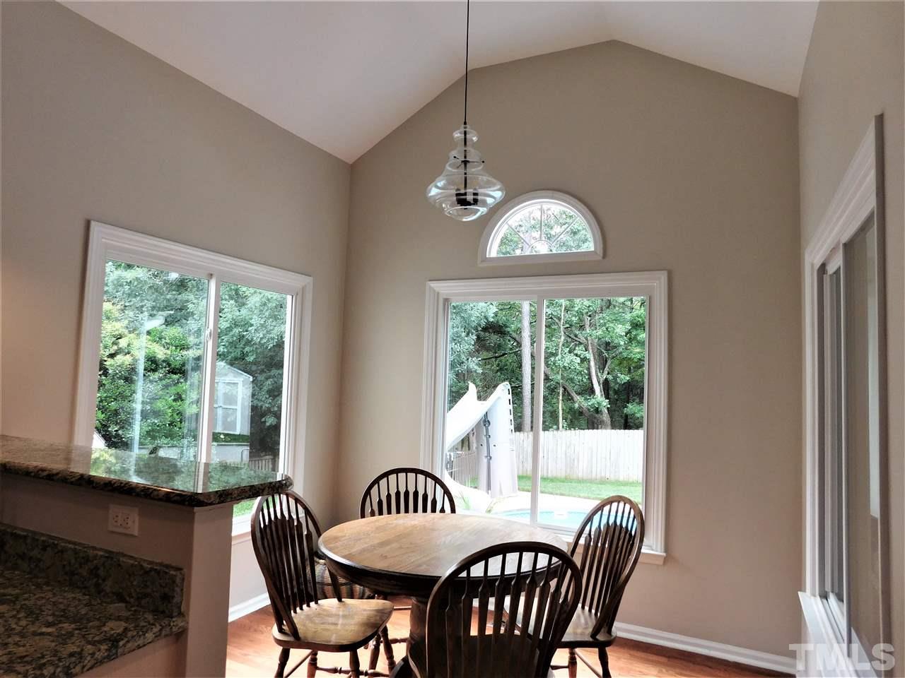 2332 Finley Ridge Lane Raleigh, NC 27615 - Photo 11 of 30 a view of a dining room with furniture a chandelier and wooden floor