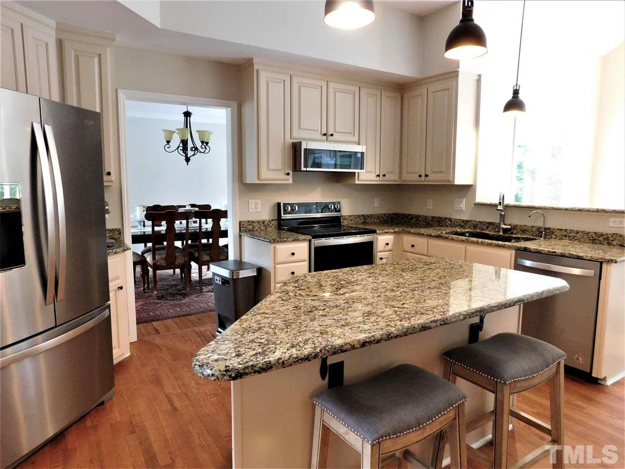 2332 Finley Ridge Lane Raleigh, NC 27615 - Photo 13 of 30 a kitchen with stainless steel appliances granite countertop a sink refrigerator and microwave