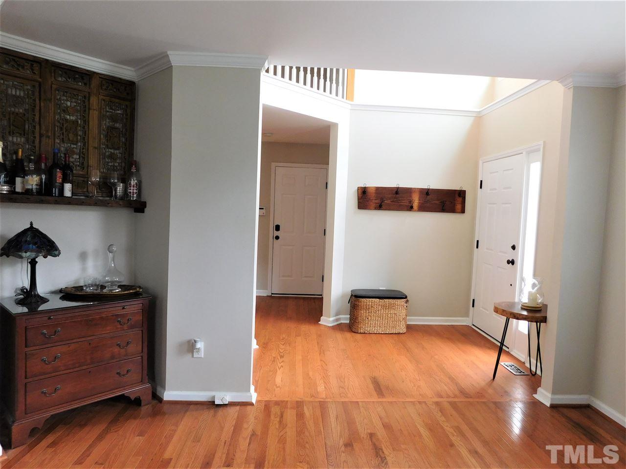 2332 Finley Ridge Lane Raleigh, NC 27615 - Photo 3 of 30 a view of a hallway with wooden floor and furniture