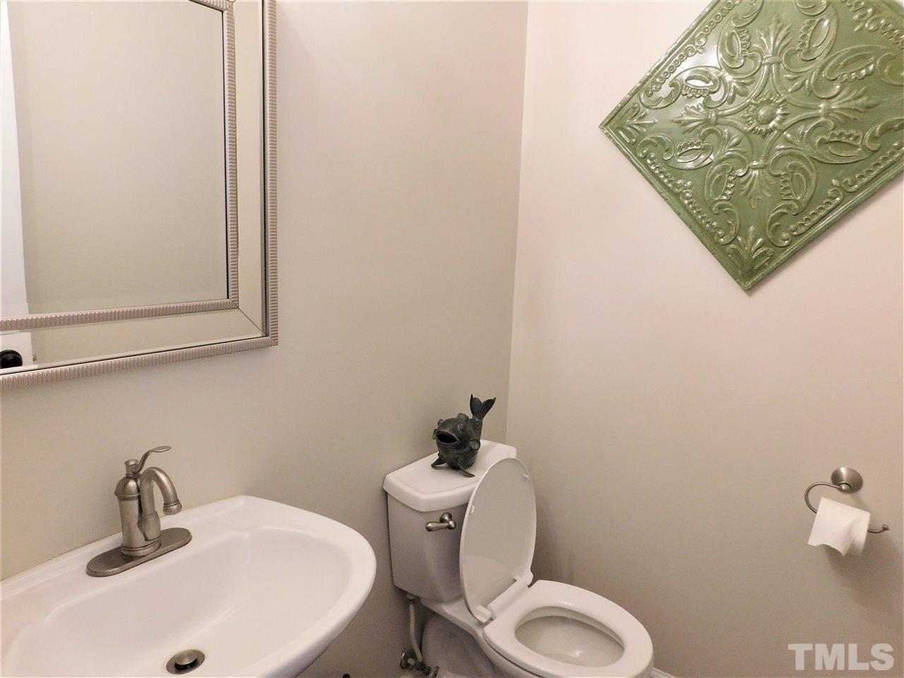 2332 Finley Ridge Lane Raleigh, NC 27615 - Photo 30 of 30 a bathroom with a toilet sink and mirror