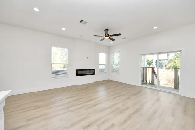 a living room with furniture a flat screen tv and a large window