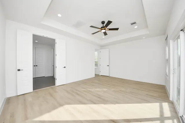 a spacious bathroom with a granite countertop sink mirror and cabinets