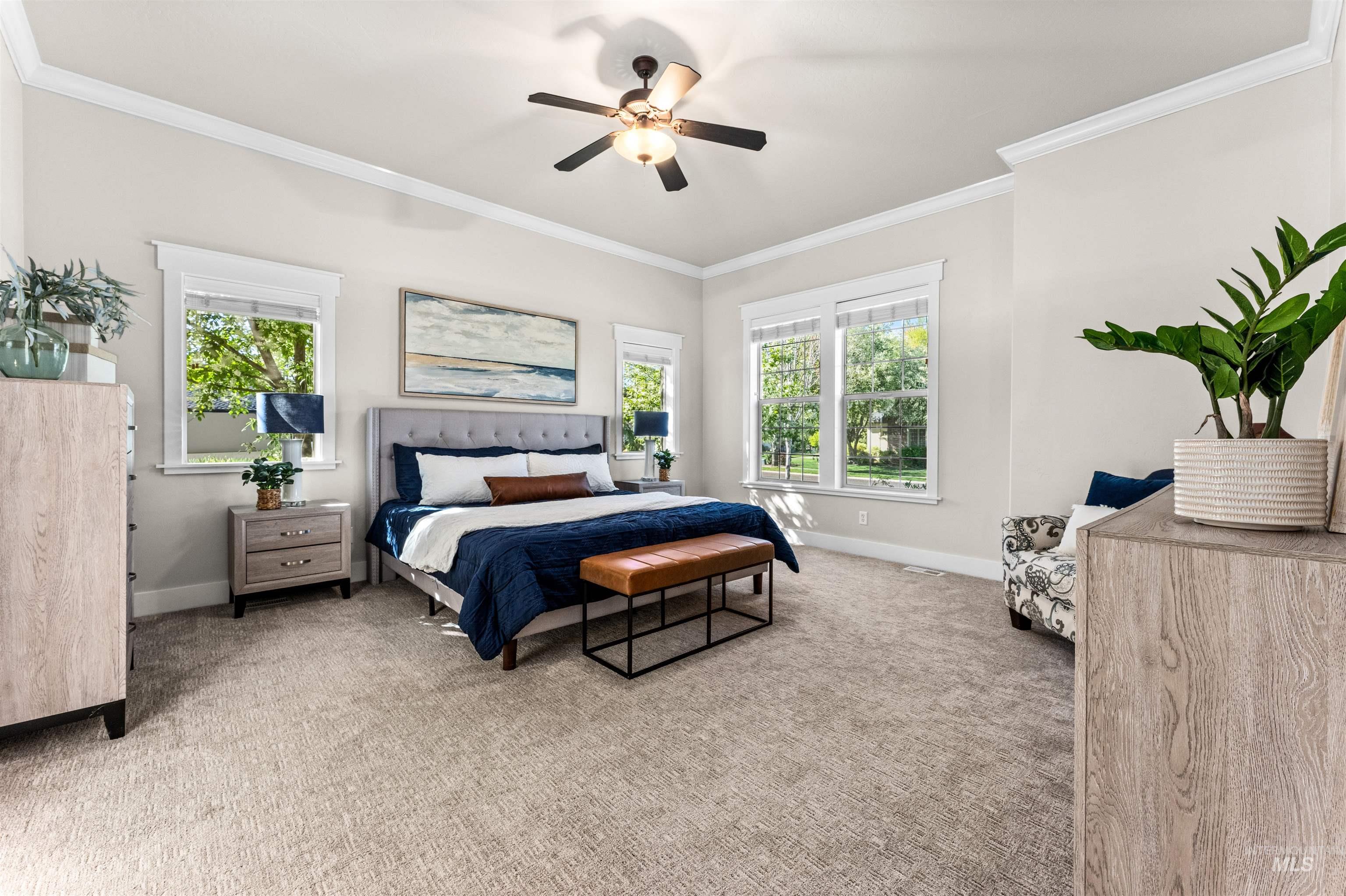 1177 East Riversong Drive Eagle, ID 83616 - Photo 12 of 36 Bedroom with light carpet, crown molding, multiple windows, and a ceiling fan