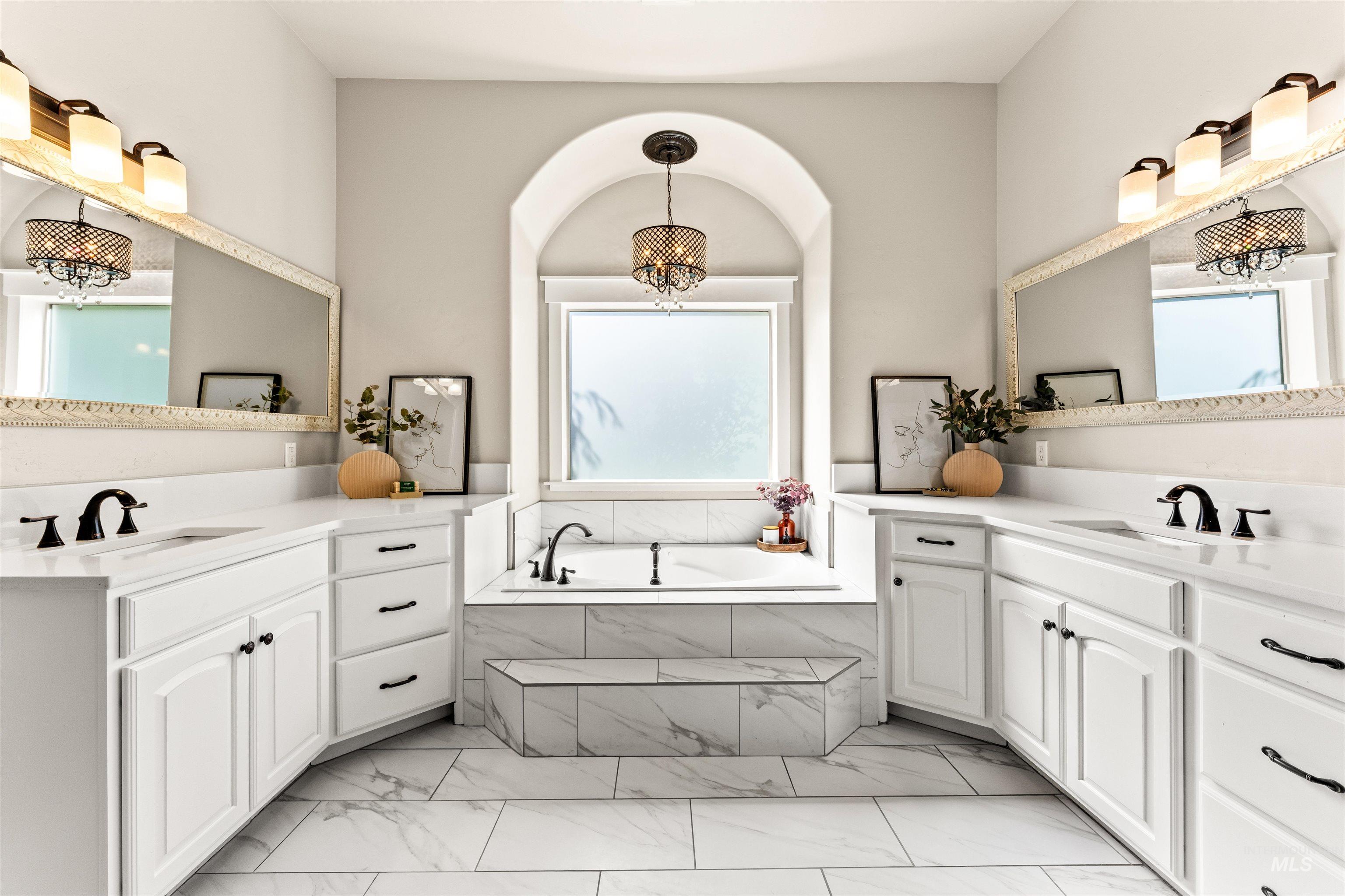 1177 East Riversong Drive Eagle, ID 83616 - Photo 13 of 36 Bathroom with two vanities, a garden tub, and light marble finish flooring