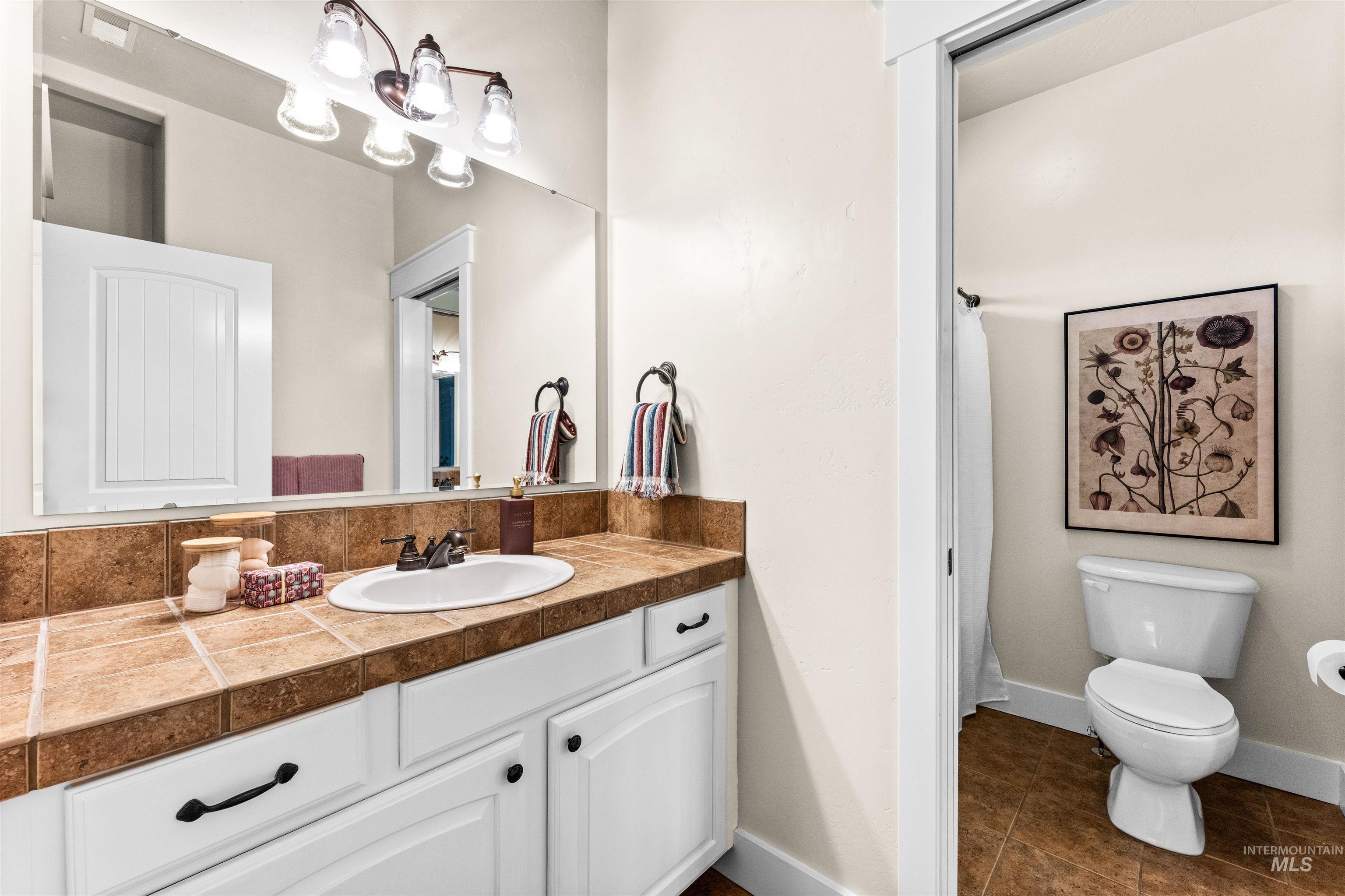 1177 East Riversong Drive Eagle, ID 83616 - Photo 22 of 36 Bathroom with vanity and dark tile patterned floors