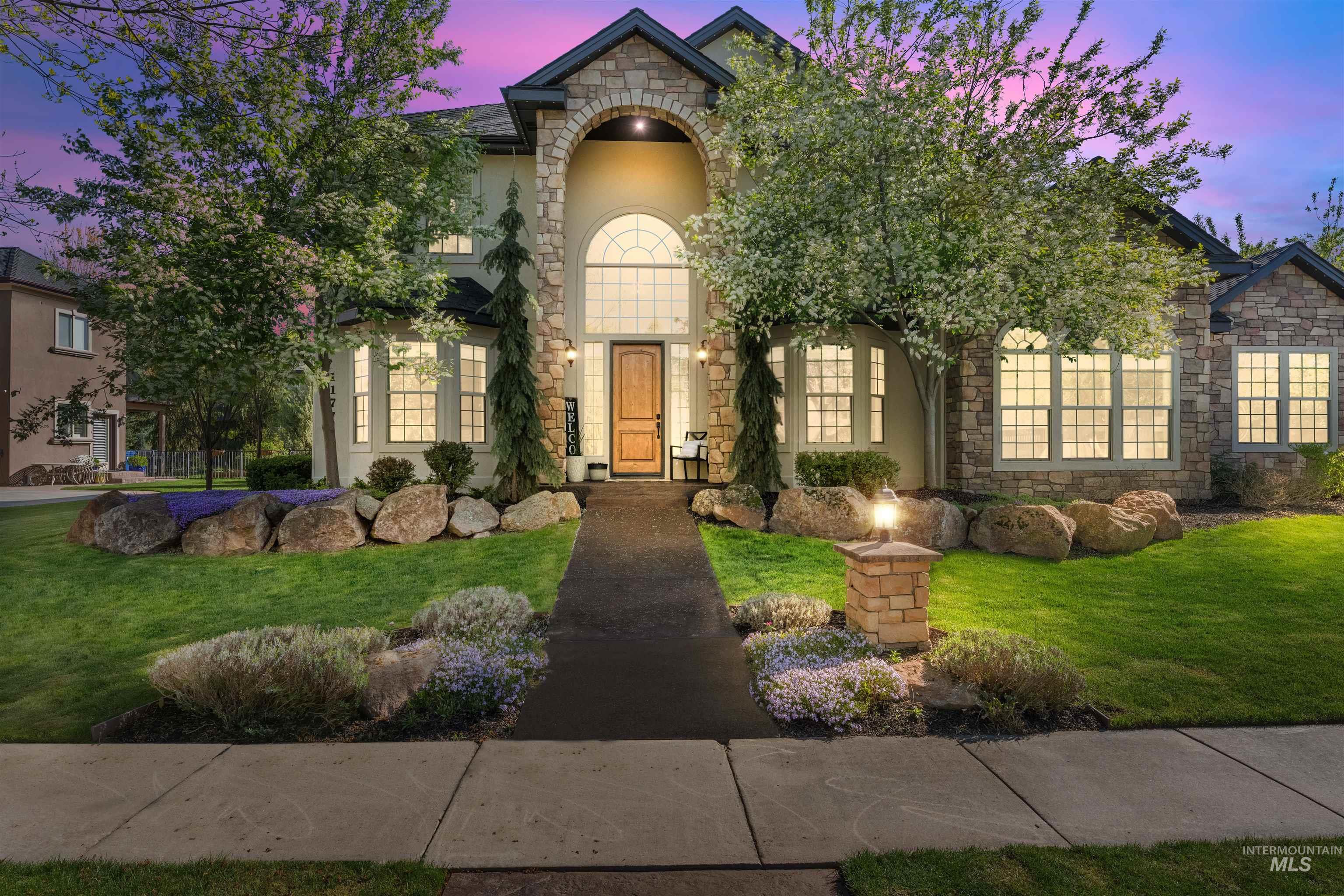 1177 East Riversong Drive Eagle, ID 83616 - Photo 29 of 36 View of front of property featuring stone siding, a front lawn, and stucco siding