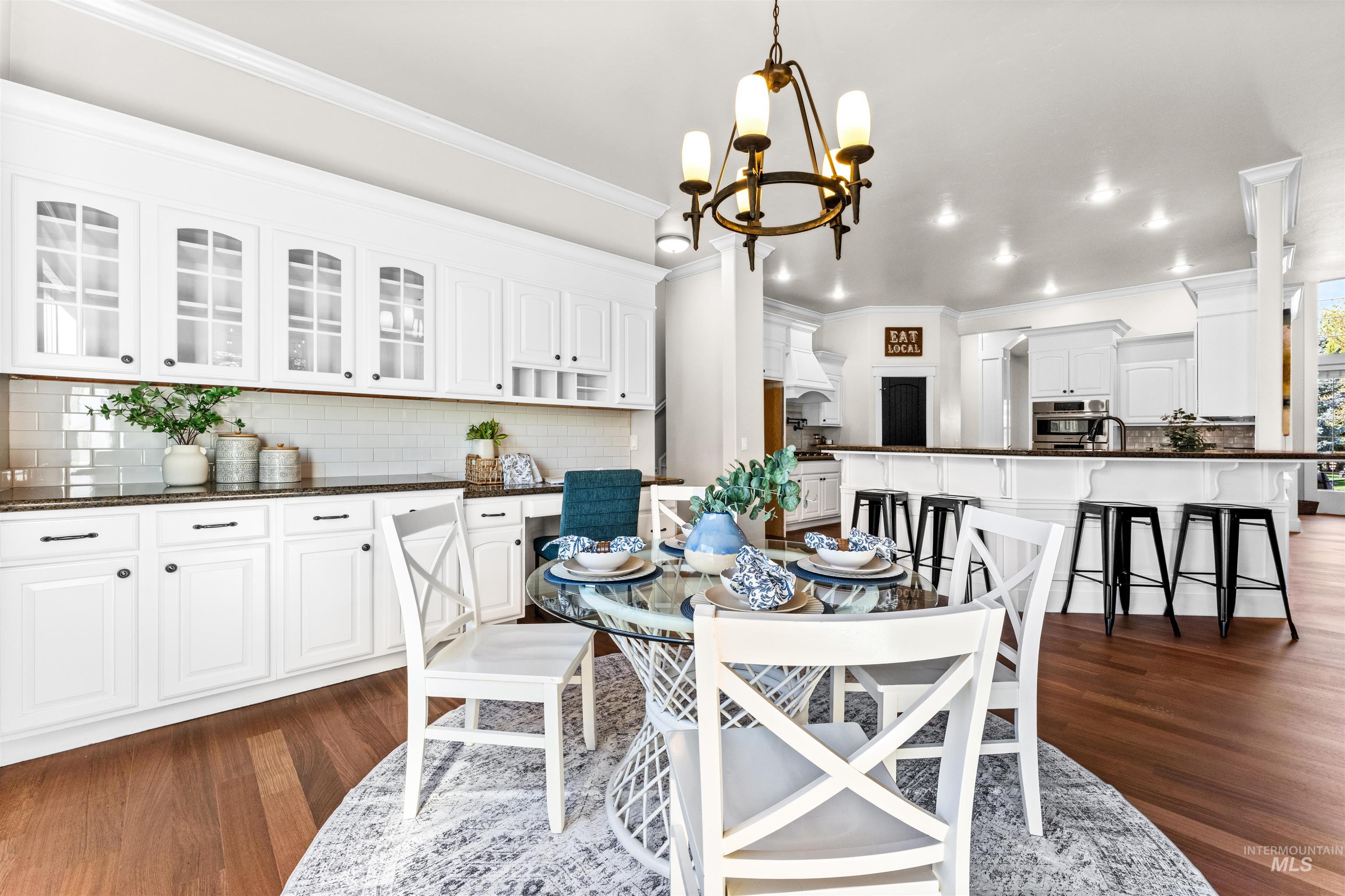 1177 East Riversong Drive Eagle, ID 83616 - Photo 9 of 36 Dining room with dark wood-type flooring, hanging lights, and crown molding