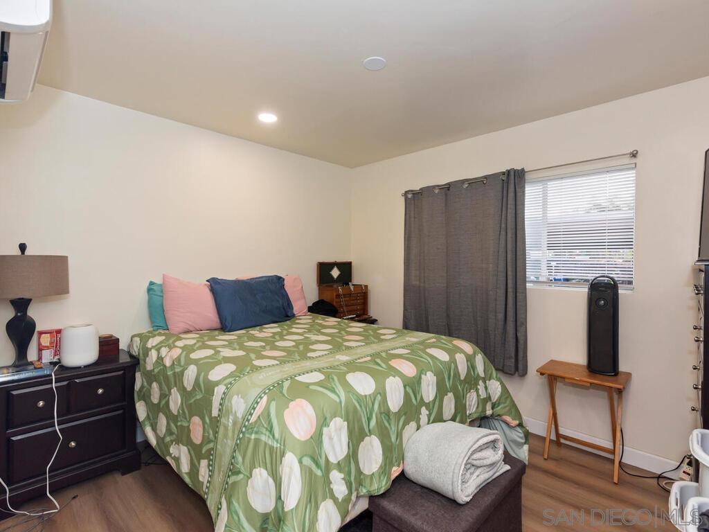 1027 Chestnut Street Escondido, CA 92025 - Photo 15 of 35 a bed sitting in a bedroom and dresser with wooden floor