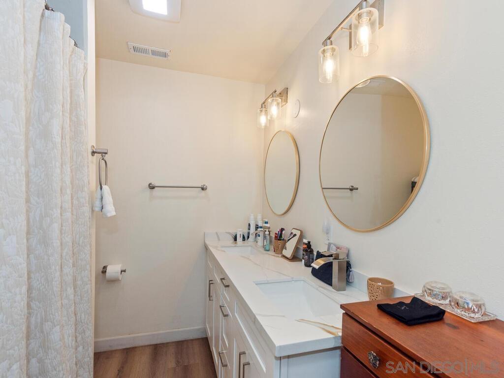 1027 Chestnut Street Escondido, CA 92025 - Photo 16 of 35 a bathroom with a sink and a mirror