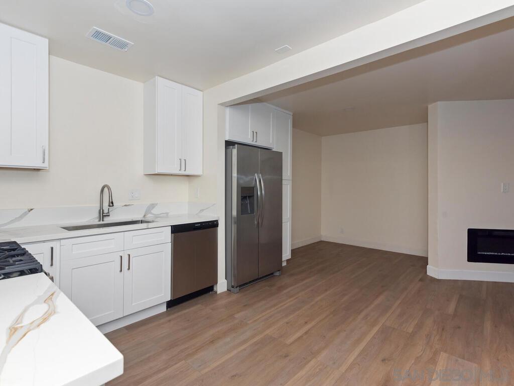 1027 Chestnut Street Escondido, CA 92025 - Photo 7 of 35 a kitchen with a refrigerator and a sink