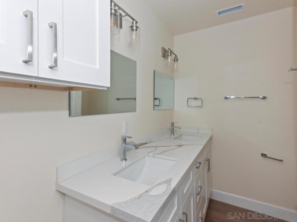 1027 Chestnut Street Escondido, CA 92025 - Photo 9 of 35 a bathroom with a sink and a mirror
