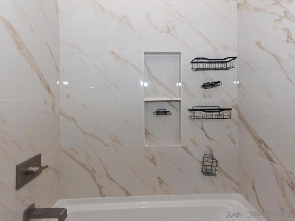 1027 Chestnut Street Escondido, CA 92025 - Photo 10 of 35 a bathroom with a bathtub and a shower