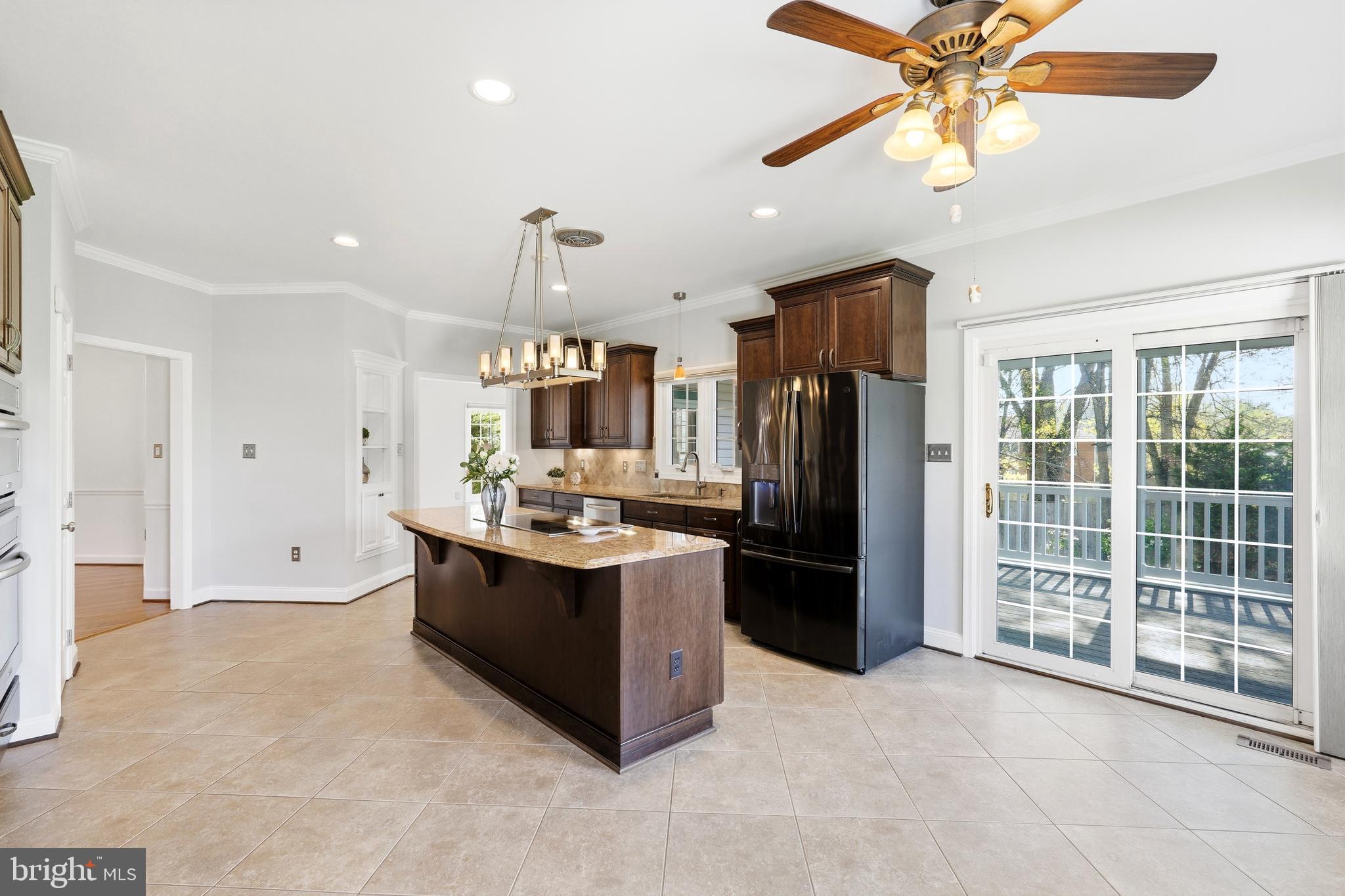 3714 Monitor Place Olney, MD 20832 - Photo 12 of 49 a large kitchen with kitchen island a large counter space a sink stainless steel appliances and cabinets