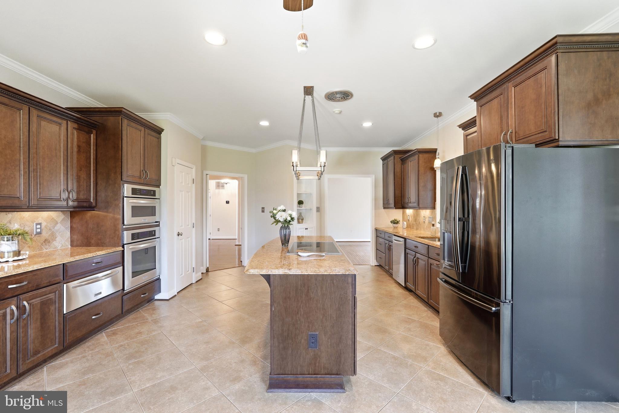 3714 Monitor Place Olney, MD 20832 - Photo 14 of 49 a large kitchen with kitchen island a refrigerator a sink a stove and cabinets