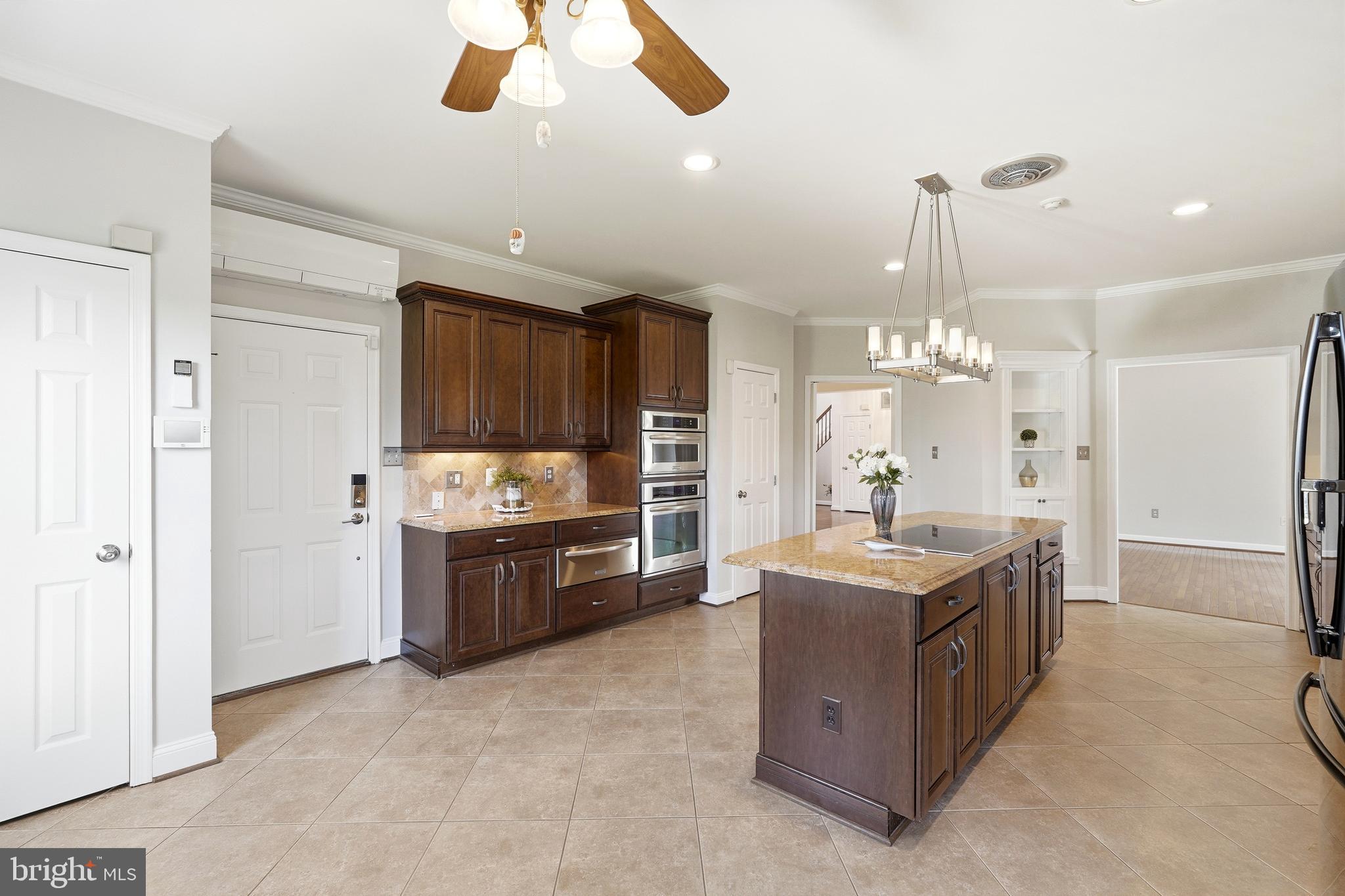 3714 Monitor Place Olney, MD 20832 - Photo 15 of 49 a large kitchen with kitchen island a sink stainless steel appliances and cabinets