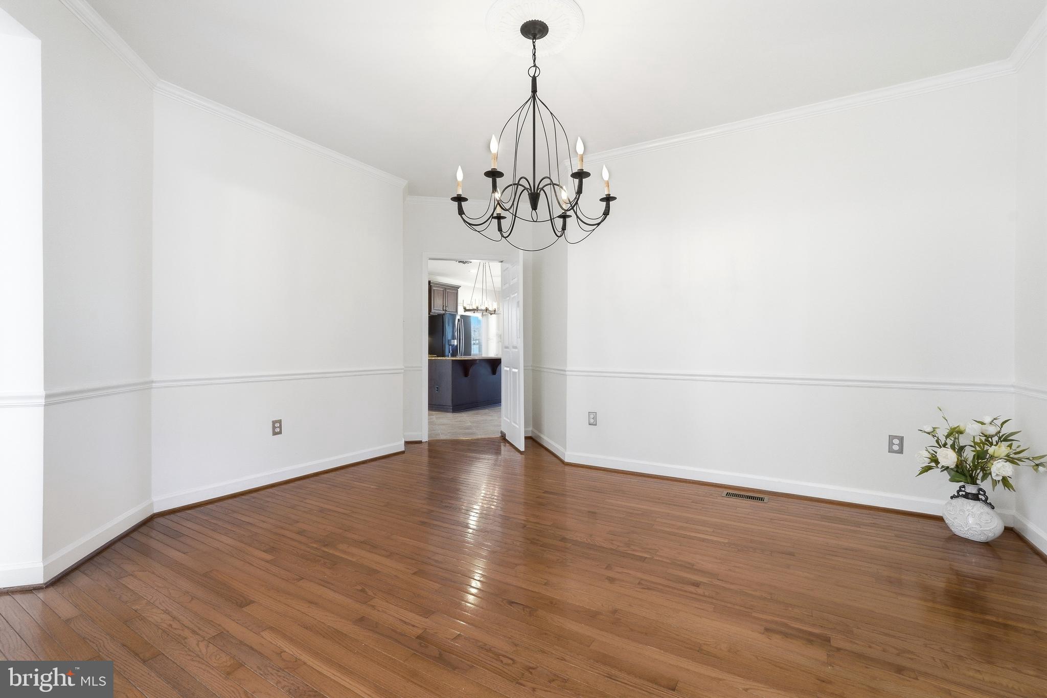 3714 Monitor Place Olney, MD 20832 - Photo 17 of 49 a view of a hallway with wooden floor and a chandelier