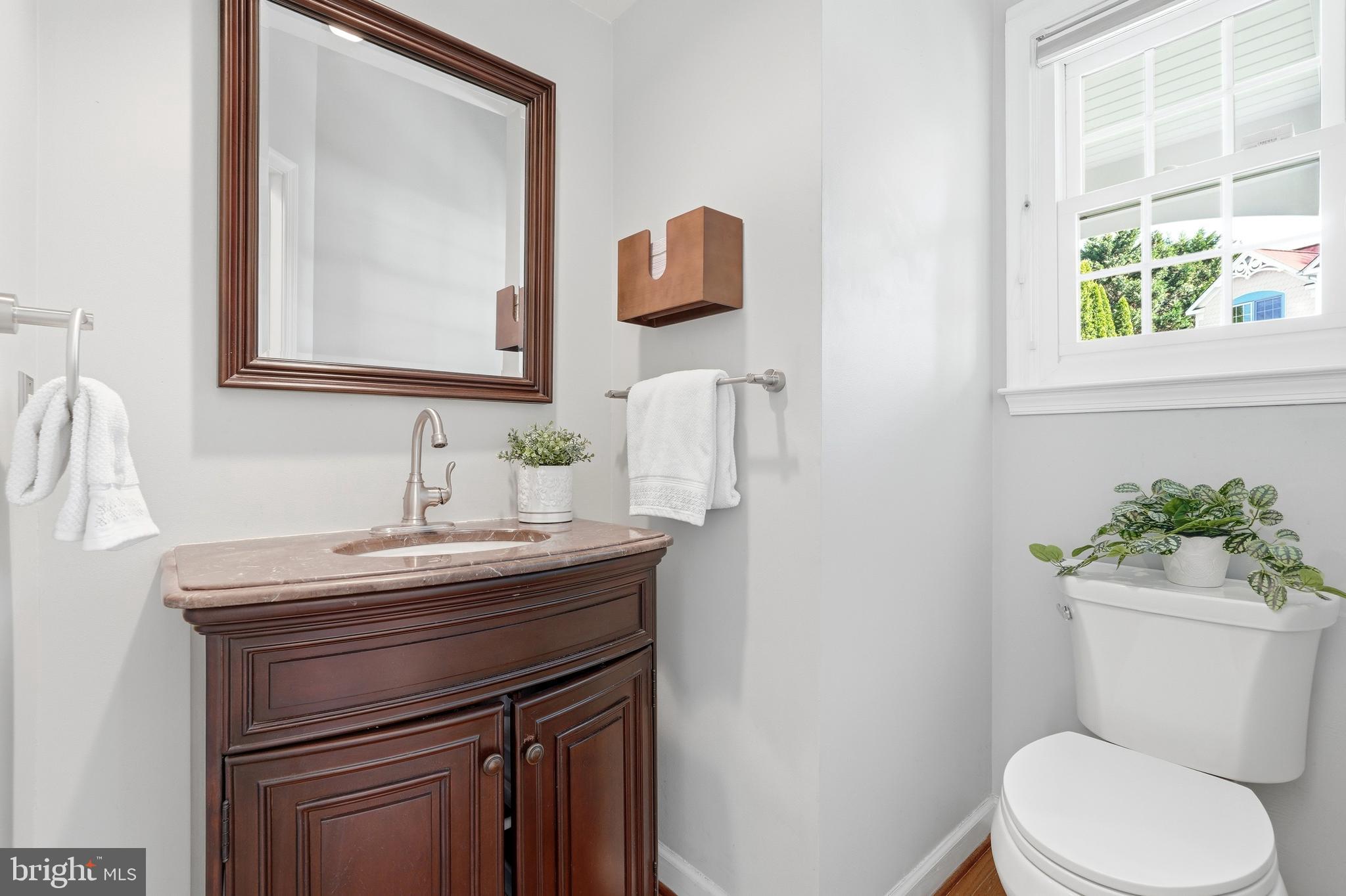 3714 Monitor Place Olney, MD 20832 - Photo 21 of 49 a bathroom with a toilet a sink a mirror a window and vanity