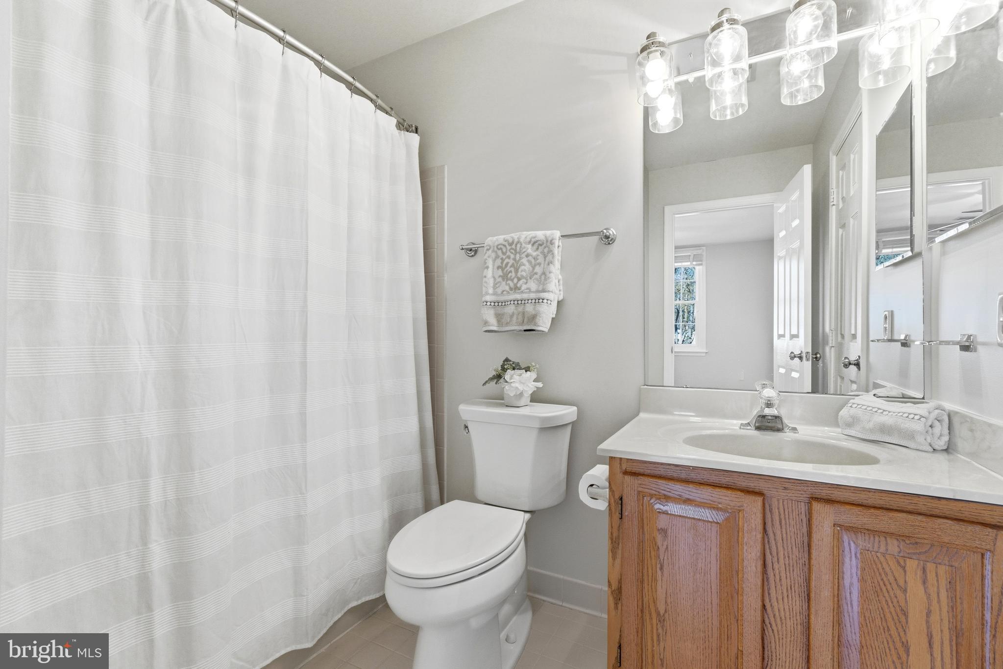 3714 Monitor Place Olney, MD 20832 - Photo 28 of 49 a bathroom with a sink a toilet and shower curtain