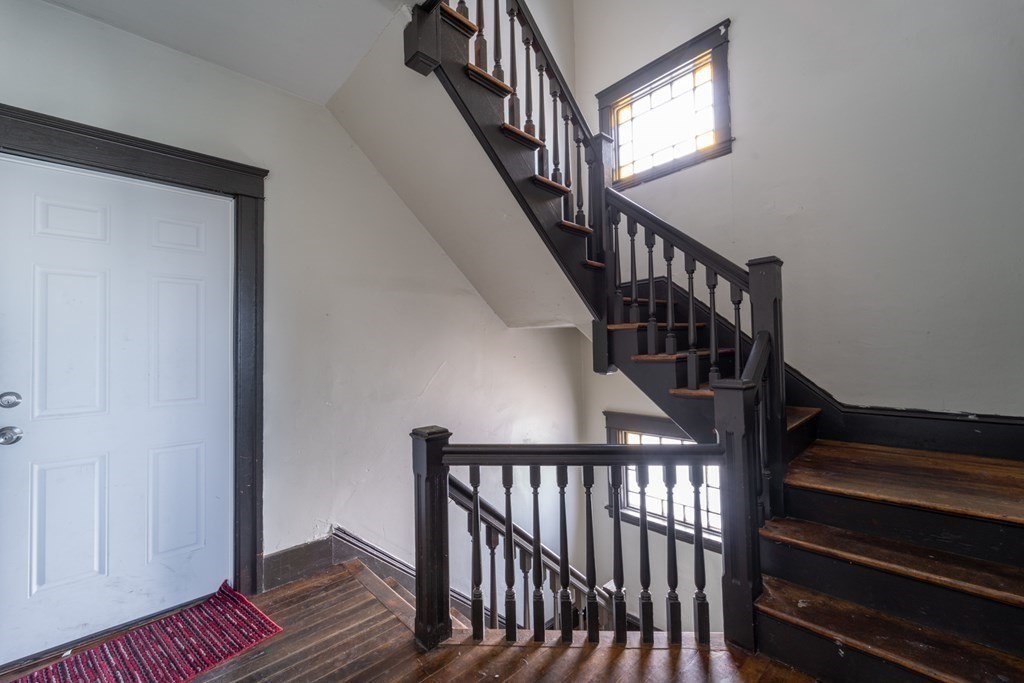 217 Beacon Street Worcester, MA 01610 - Photo 17 of 39 a view of staircase with wooden floor and white walls