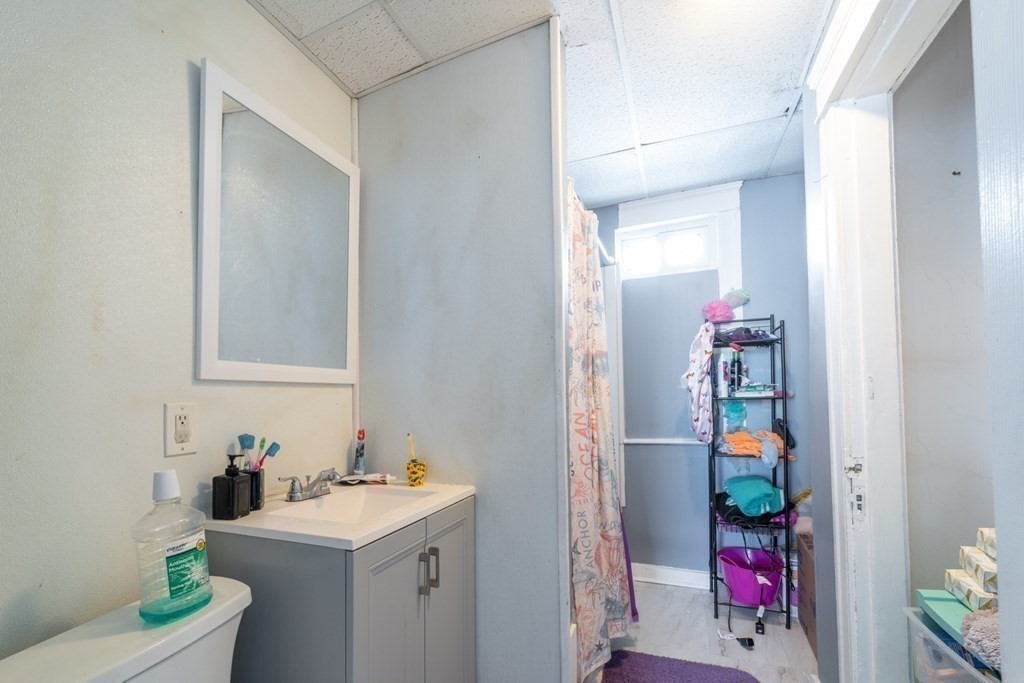 217 Beacon Street Worcester, MA 01610 - Photo 20 of 39 a bathroom with a sink vanity mirror and toilet