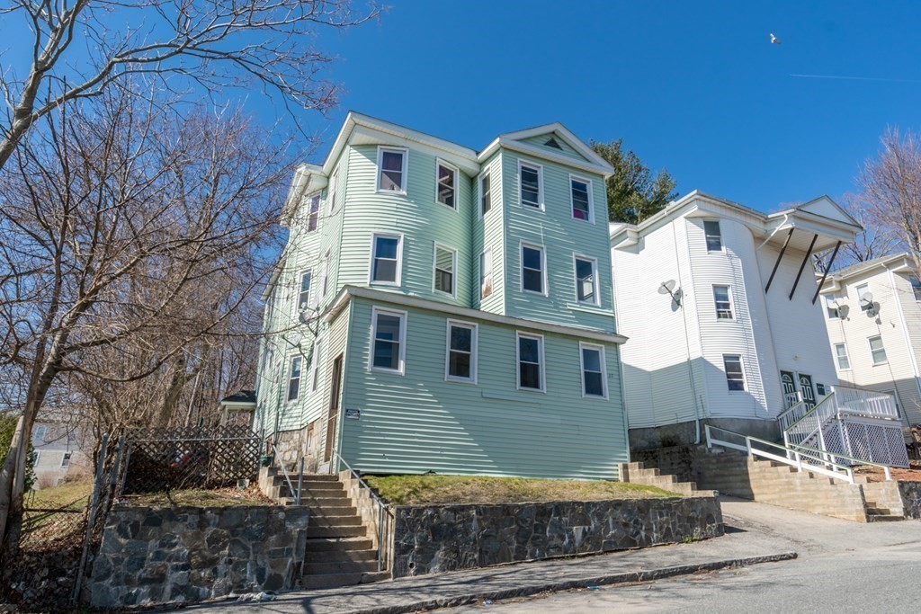 217 Beacon Street Worcester, MA 01610 - Photo 2 of 39 a front view of a house with a yard