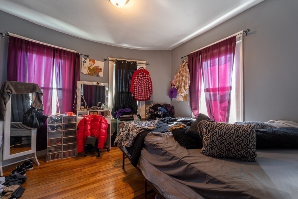 217 Beacon Street Worcester, MA 01610 - Photo 22 of 39 a bed room with a bed and a window
