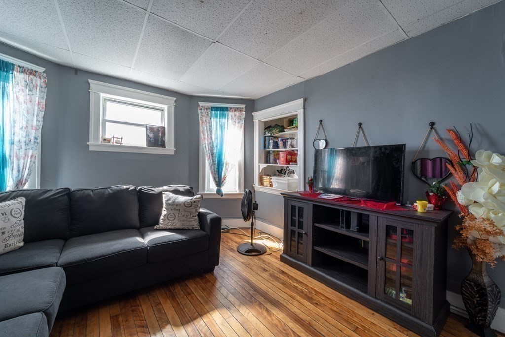 217 Beacon Street Worcester, MA 01610 - Photo 23 of 39 a living room with furniture and a flat screen tv