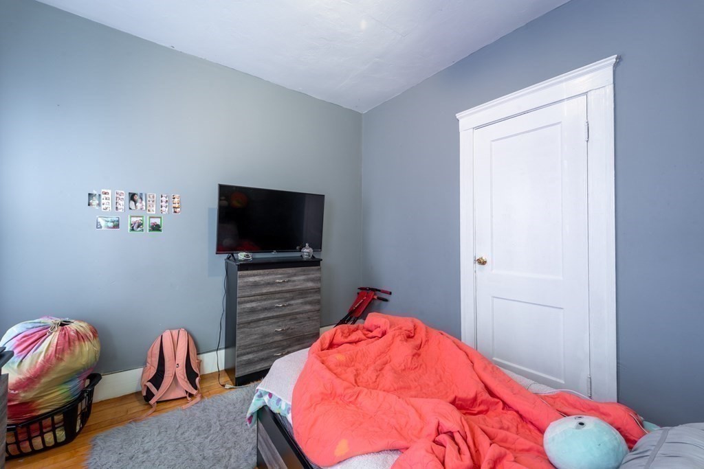 217 Beacon Street Worcester, MA 01610 - Photo 25 of 39 a bedroom with a bed and a flat screen tv