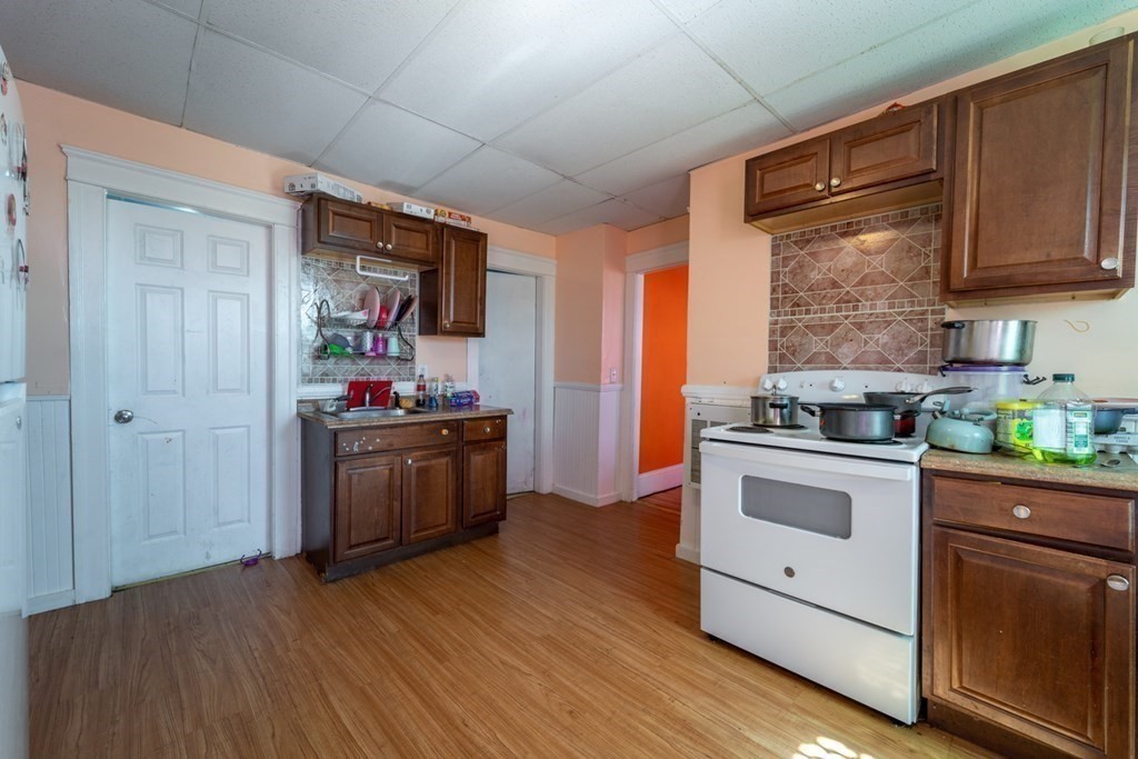 217 Beacon Street Worcester, MA 01610 - Photo 29 of 39 a kitchen with stainless steel appliances a stove top oven a sink and a refrigerator