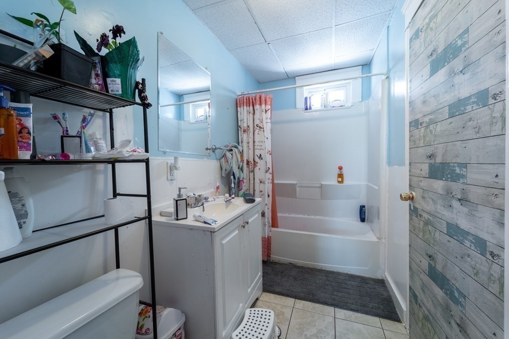 217 Beacon Street Worcester, MA 01610 - Photo 30 of 39 a bathroom with a sink a toilet and shower