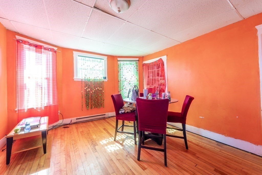 217 Beacon Street Worcester, MA 01610 - Photo 31 of 39 a view of a dining room with furniture window and wooden floor