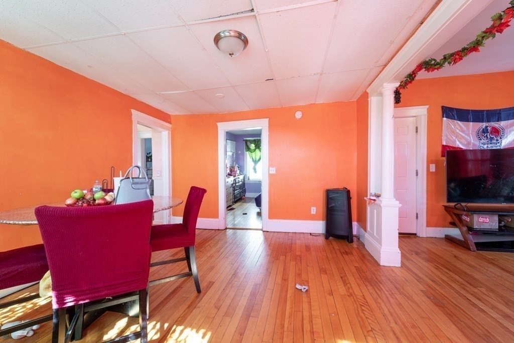 217 Beacon Street Worcester, MA 01610 - Photo 33 of 39 a view of a dining room with furniture and wooden floor