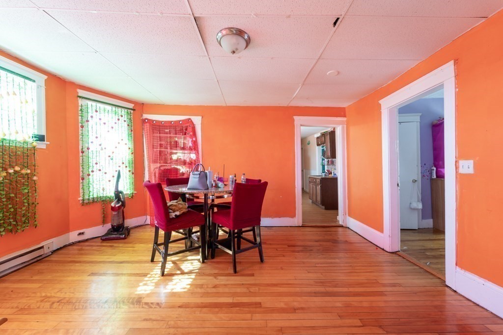 217 Beacon Street Worcester, MA 01610 - Photo 34 of 39 a view of a dining room with furniture window and wooden floor