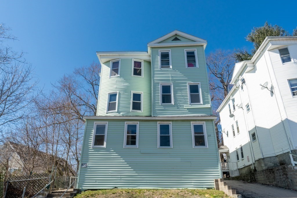 217 Beacon Street Worcester, MA 01610 - Photo 37 of 39 a front view of a house with a yard