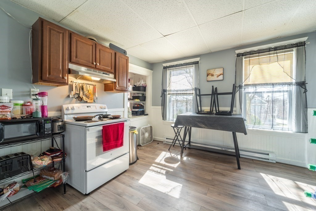 217 Beacon Street Worcester, MA 01610 - Photo 5 of 39 a kitchen with stainless steel appliances granite countertop a stove a sink and a refrigerator