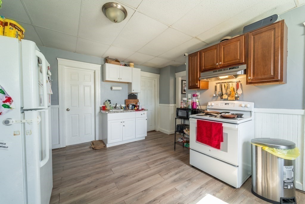 217 Beacon Street Worcester, MA 01610 - Photo 7 of 39 a kitchen with stainless steel appliances granite countertop a refrigerator sink and stove