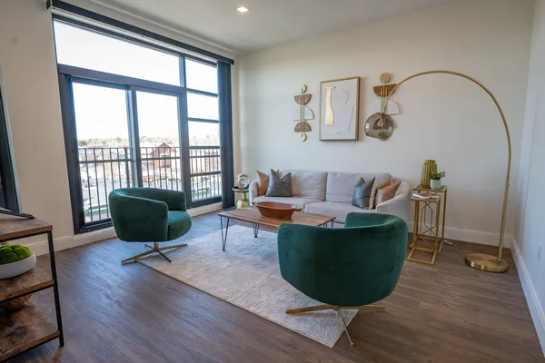 a living room with furniture a rug and a window