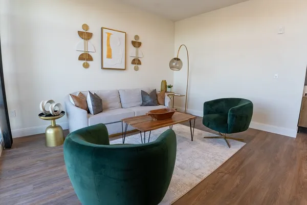 a living room with furniture and wooden floor