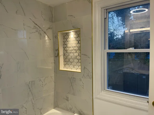 a spacious bedroom with a bed and a window